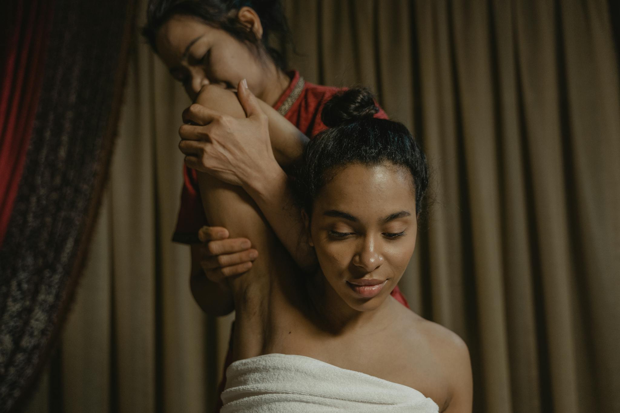 A calming massage therapy session indoors with focus on relaxation and stretching.